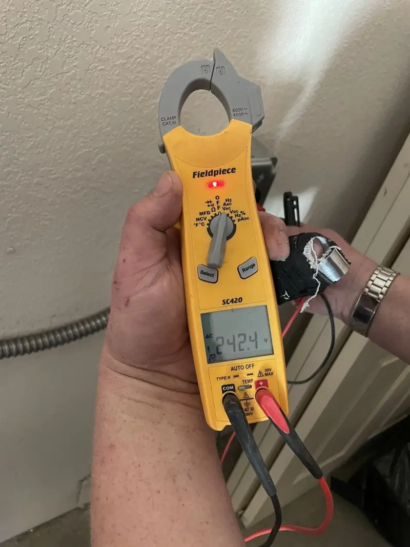 Voltage testing with clamp meter during Ceiling Fan Installation in Hicksville